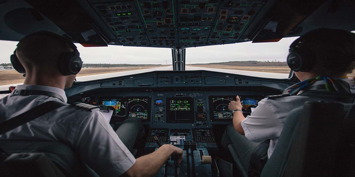 Two pilots in the cockpit of a plane
